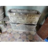 A pair of weathered cast composition stone garden planters of rectangular form with canted corners