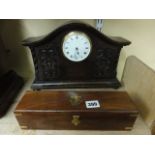 An Edwardian oak mantle clock, the shaped case with carved detail with convex enamel dial and 8