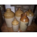 Five vintage stoneware flagons and jars, three with impressed merchants marks for Warn & Sons,