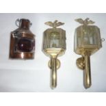 A pair of reproduction brass wall lanterns (electric), each set with a seated eagle finial with