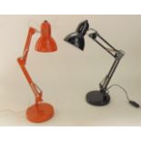 A contemporary anglepoise type desk lamp on an adjusting frame in an orange colourway raised on a