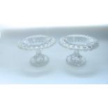 A pair of good quality heavy 19th century clear cut pedestal bowls, the extensively cut rim set