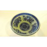 A 19th century Chinese basin of circular form with blue and white painted decoration of flowers to