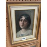 A late 19th century continental oil painting on board, shoulder length study of a young woman gazing