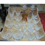 A box containing a quantity of clear cut drinking glasses, glass candlesticks, etc