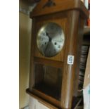 An oak cased wall hanging clock marked to dial Kieninger and with 2-train movement