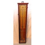 An Admiral Fitzroy barometer set within a mahogany framework with printed paper background