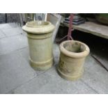 Two small reclaimed buff coloured clay chimney pots of cylindrical form