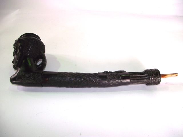 A substantial African carved hardwood pipe, the bowl in the form of a facial study with further