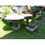 A pair of weathered cast composition stone campana shaped garden urns with squat circular bowls