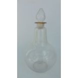 A 19th century clear glass carboy, the base of bulbous form with drawn neck and flared rim