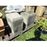 A pair of unusual weathered cast composition stone wedge shaped plinths