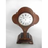 An Edwardian balloon shaped mantle clock with mother of pearl and satin wood inlay detail