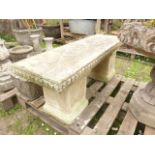 A weathered contemporary cast composition stone 3-sectional garden bench, the rectangular slab