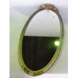 An oval Barbola mirror with applied and painted floral detail
