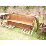 A pair of Victorian pitch pine church pews with plank seats, panelled backs, rolled rails, chamfered