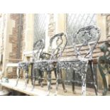 A set of three cast metal balloon back garden chairs with foliate detail and pierced lattice work