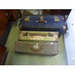 Three vintage canvas and leather reinforced suitcases of varying design, together with a vintage