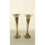 A pair of Edwardian silver vases, Hayes & Co., Birmingham, 1909, each of plain trumpet form, loaded,