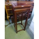 A Chinese hardwood plant stand of square cut and moulded form