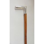 A malacca walking cane terminating in a silver handle