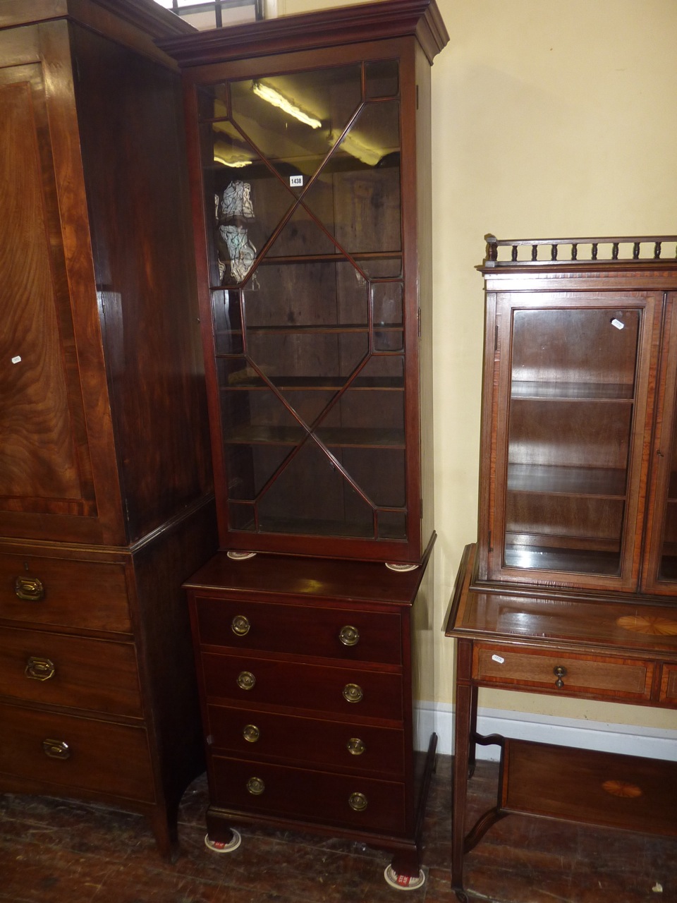 A 19th century mahogany side cabinet, the lower section enclosed by four frieze drawers, the upper