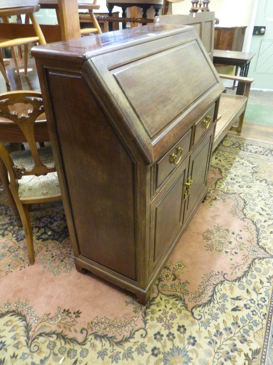 A Chinese rosewood writing bureau, the fall flap enclosing a simply fitted interior over two drawers