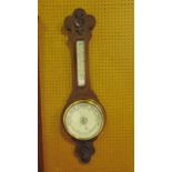 An Edwardian oak aneroid barometer with ceramic dials and carved casework