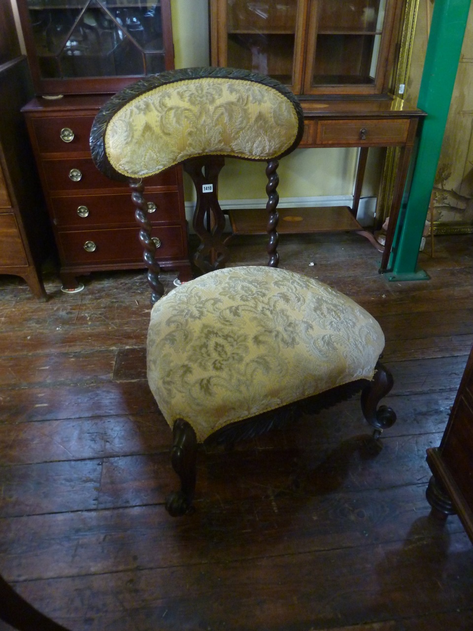 A 19th century drawing room chair with wide bodied seat, the raised back with tapering spiral column