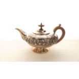 A William IV silver teapot, indecipherable maker's mark, London, 1830, of circular form, chased with