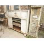 A substantial late 19th century painted pine freestanding side cupboard enclosed by two pairs of