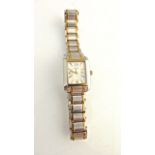 A lady's two-tone stainless steel wristwatch, Rotary, the rectangular silvered dial with gilt