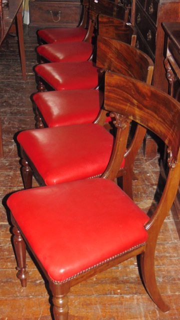 A set of six William IV mahogany spade back dining chairs with carved detail, fluted supports and