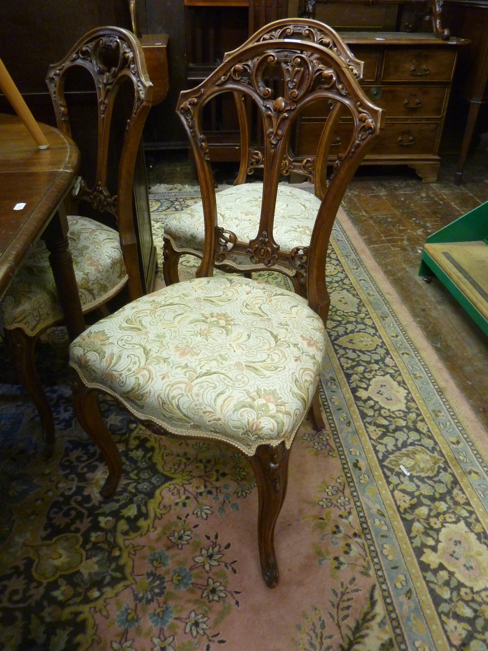 A set of four Victorian walnut dining chairs, the backs with well presented c-scroll, floral and - Image 2 of 2
