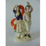 A 19th century Staffordshire figure group of a pair of theatrical characters, she dancing with an