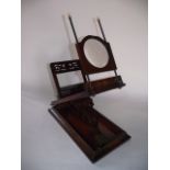 A good quality 19th century desk top zogroscope, the hinged rectangular base supporting an