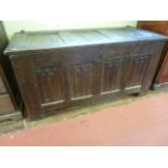 An early English oak coffer, the front elevation enclosed by four panels with carved linenfold