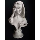 A white resin (to simulate marble) bust of a classically modelled female, her flowing hair decorated