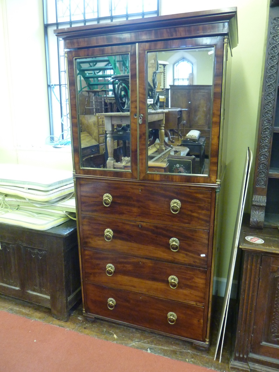 A Georgian mahogany gentleman's bedroom cabinet, the lower section enclosed by four drawers, the