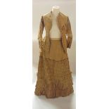 A good quality Victorian two-piece costume, comprising a jacket and skirt in pale olive/gold silk