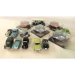 A collection of Heritage Formula 1 die cast model racing cars and a miniature Formula 1 helmet,