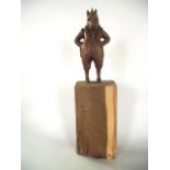 A carved timber study, seemingly of a boar standing on hind legs wearing Elizabethan clothing,