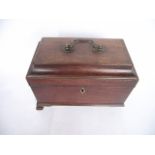A good quality Georgian mahogany veneered tea caddy of sarcophagus form, the hinged lid bearing a