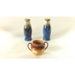 A pair of Royal Doulton vases of shaped cylindrical form with blue glaze to the lower section and