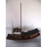 An early 20th century (c1930) Chinese timber built model of a two mast ship, highly detailed with