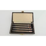 A cased set of four sterling silver bridge card retractable pencils, each terminal enamelled with