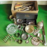 A box containing a quantity of mixed silver plated cutlery, napkin rings, an Eastern white metal