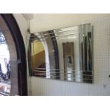 A contemporary wall mirror of rectangular form composed of numerous slender rectangular bevelled
