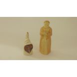 A Royal Worcester blush ivory candle snuffer in the form of a reading monk with pink printed mark to