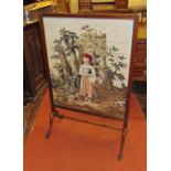 A Victorian mahogany framed fire screen raised on lions paw feet, the rectangular frame